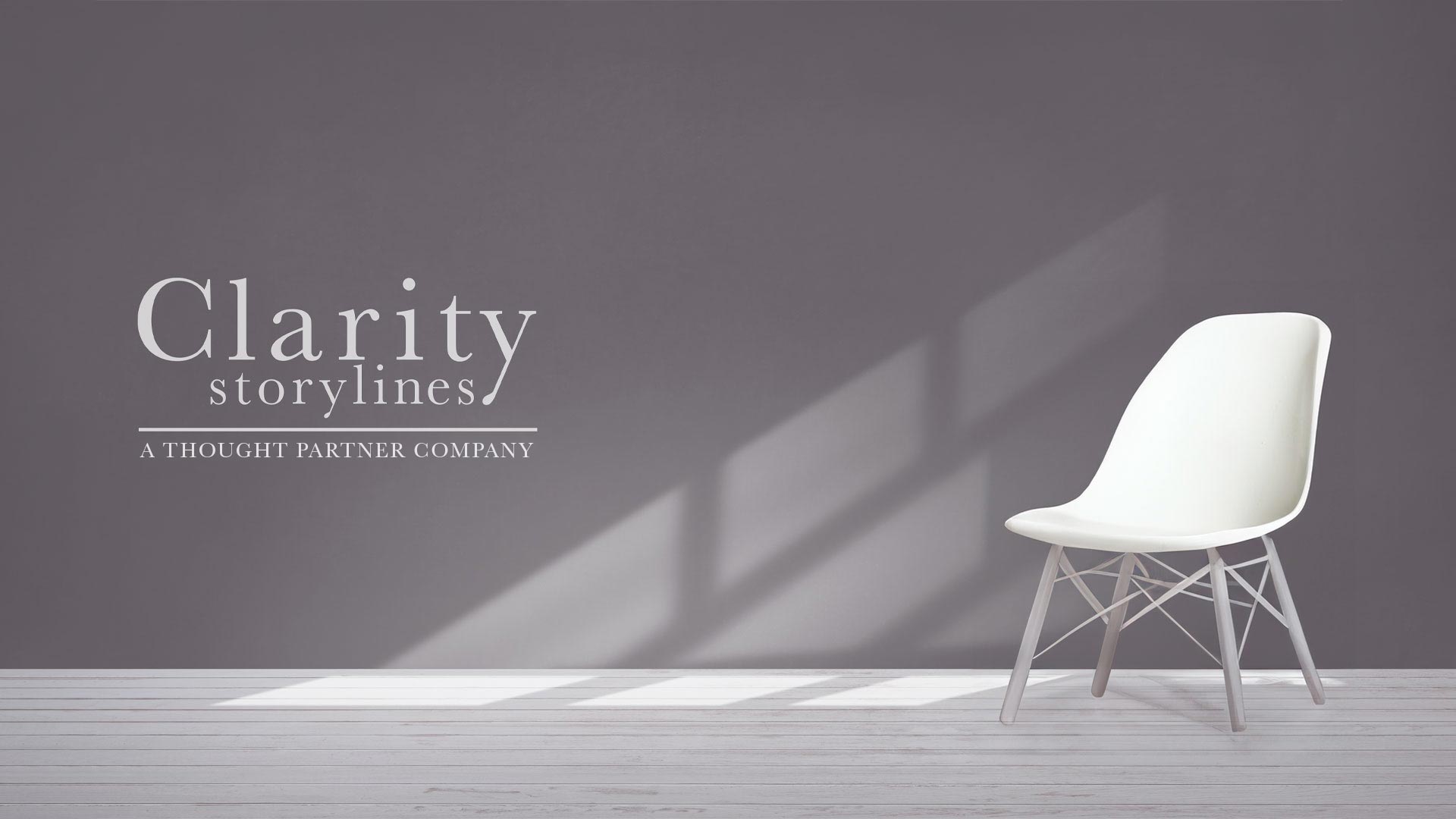 Clarity Storylines logo on wall next to a chair